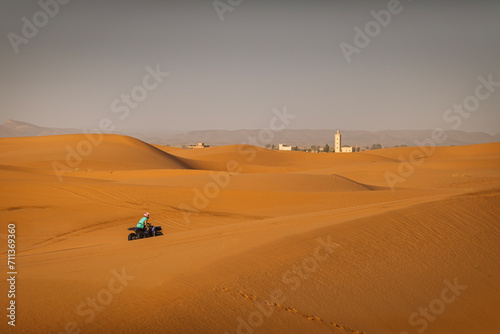 ATV machine running on desert dunes in Sahara, Merzouga, Morocco © danmir12