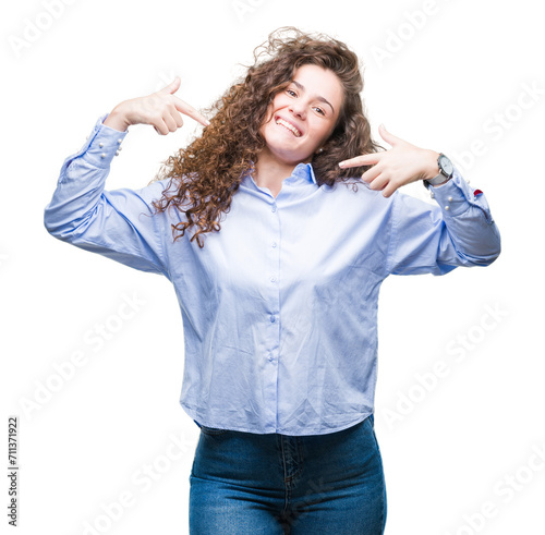 Beautiful brunette curly hair young girl wearing elgant look over isolated background looking confident with smile on face, pointing oneself with fingers proud and happy. photo