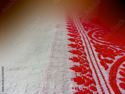 Gamosa or gamusa is a traditional textile pattern from Assam. It is a white piece of cloth with red stripes and red motifs, which is used in Bihu and resembles Ukrainian and Russian patterns. photo