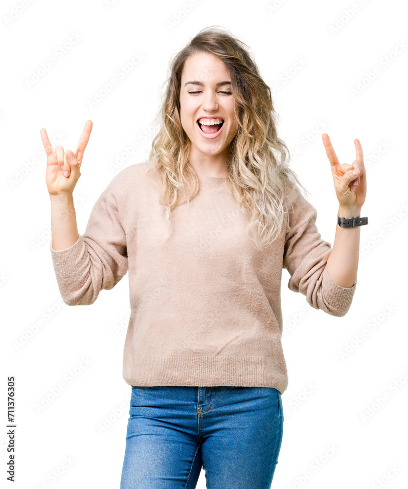 Beautiful young blonde woman wearing sweatershirt over isolated background shouting with crazy expression doing rock symbol with hands up. Music star. Heavy concept. Beautiful young blonde woman wearing sweatershirt over isolated background shouting with crazy expression doing rock symbol with hands up. Music star. Heavy concept.