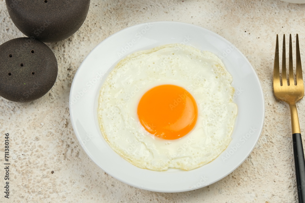 sunny side up fried egg on white table sunny side up fried egg on white table