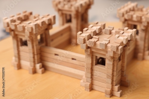 Wooden fortress on table  closeup. Children s toy