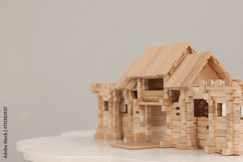 Wooden entry gate on table against light background, space for text. Children's toy Wooden entry gate on table against light background, space for text. Children's toy
