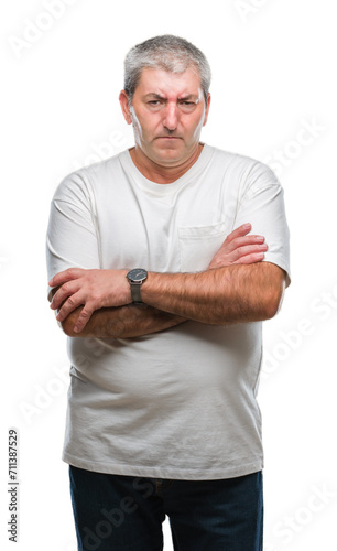 Handsome senior man over isolated background skeptic and nervous, disapproving expression on face with crossed arms. Negative person.
