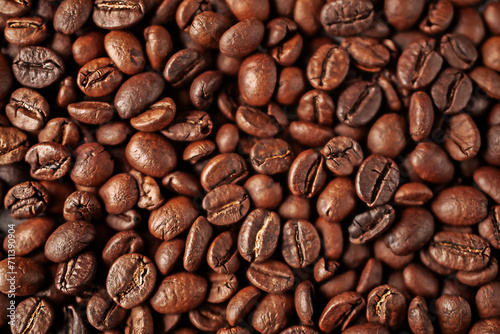 Top view of aromatic brown coffee beans lying on surface