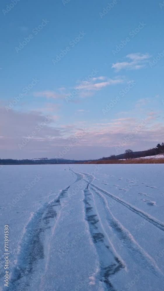Calm winter scene on the frozen lake covered with snow Calm winter scene on the frozen lake covered with snow