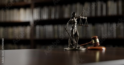 Legal Concept: Themis is the goddess of justice and the judge's gavel hammer as a symbol of law and order on the background of books