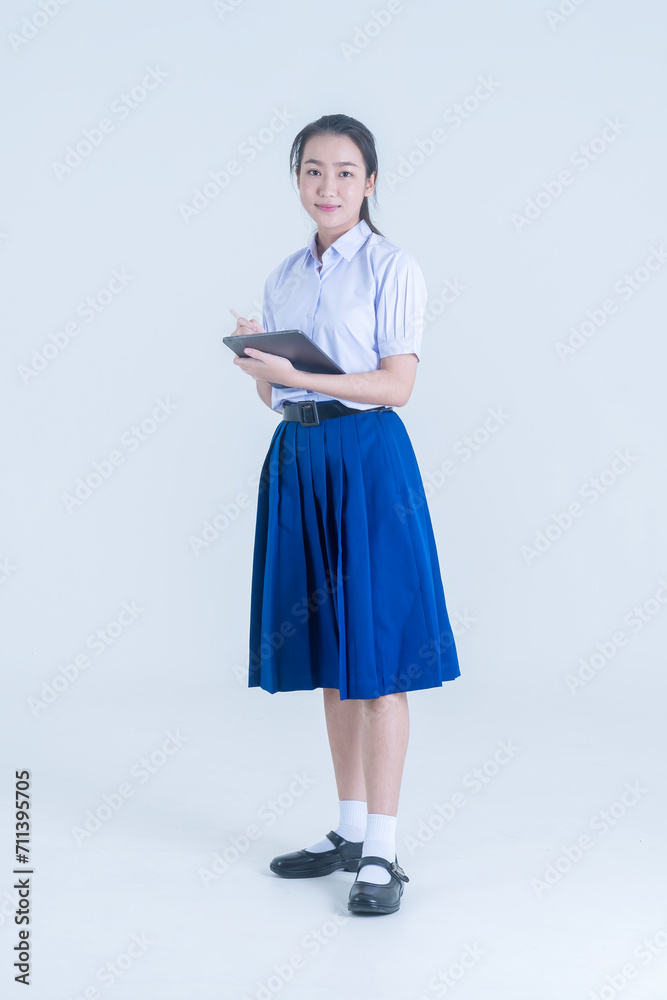 Back to school. Thai students with tablet. Girl standing and using digital tablet. Back to school. Thai students with tablet. Girl standing and using digital tablet.