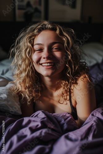smiling woman in bed with blond hair © Joachim