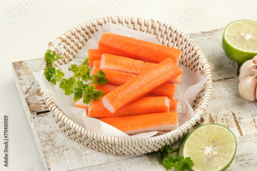 Billede på lærred fresh crab sticks with lemon on white table