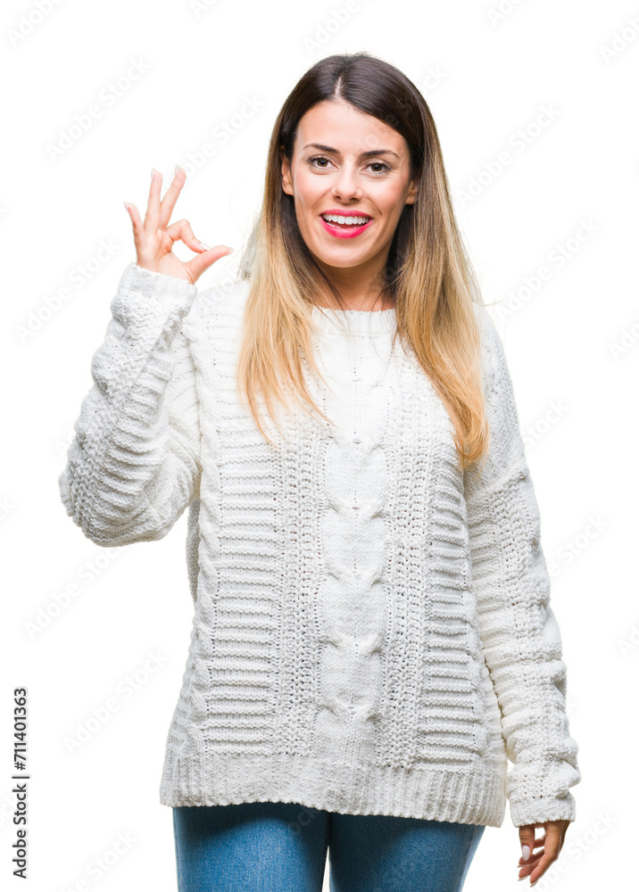 Young beautiful woman casual white sweater over isolated background smiling positive doing ok sign with hand and fingers. Successful expression. Young beautiful woman casual white sweater over isolated background smiling positive doing ok sign with hand and fingers. Successful expression.