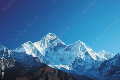 Capture the grandeur of snow-capped peaks against a clear blue sky