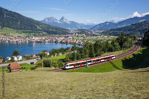 Passenger train type Stadler Flirt of Schweizerische Bundesbahnen SBB at Grosser Mythen mountain at Lake Zug in the Swiss Alps in Arth, Switzerland