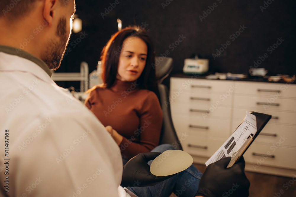Woman Discussing Breast Augmentation With Plastic Surgeon Woman Discussing Breast Augmentation With Plastic Surgeon