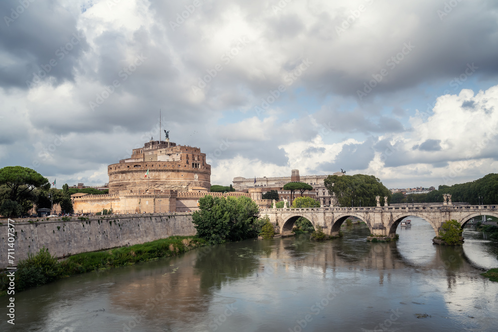 Heavy clouds above medieval St. Angelo castle and the bridge over Tiber river in Rome, Italy.