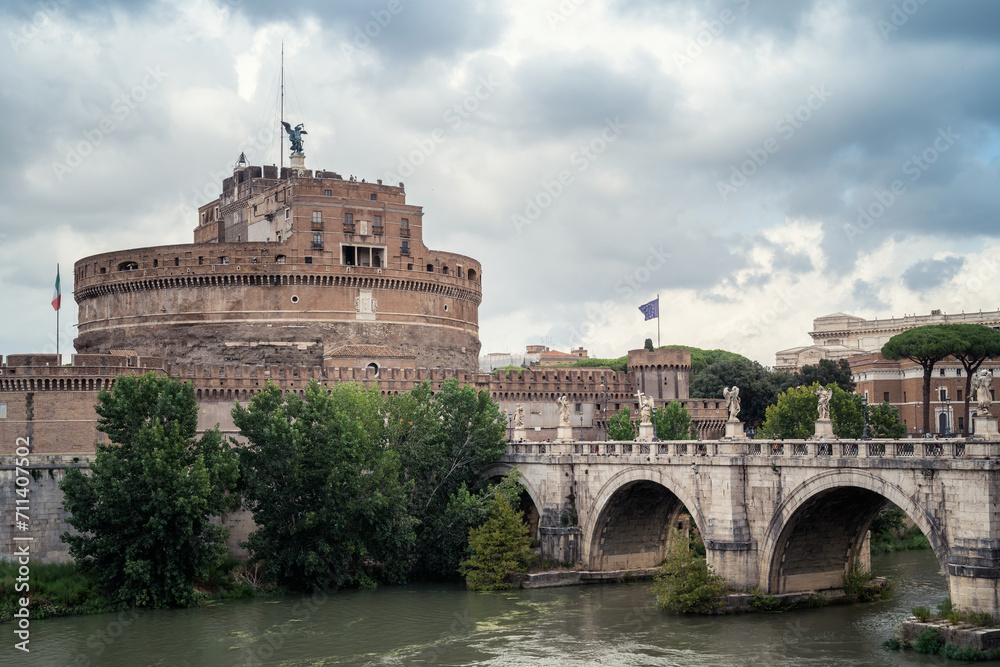 Heavy clouds above medieval St. Angelo castle and the bridge over Tiber river in Rome, Italy.