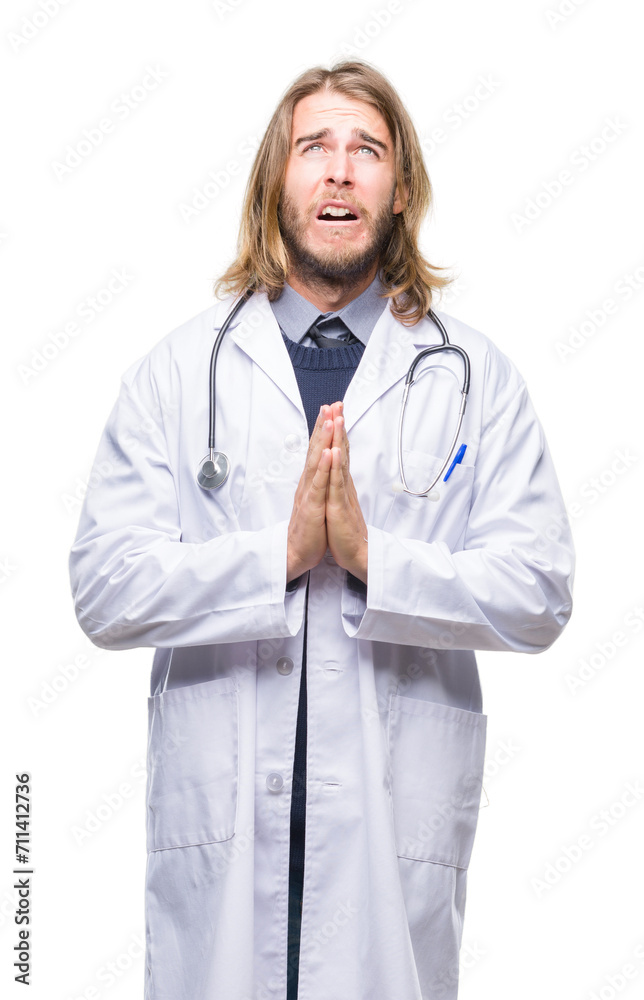 Young handsome doctor man with long hair over isolated background begging and praying with hands together with hope expression on face very emotional and worried. Asking for forgiveness Young handsome doctor man with long hair over isolated background begging and praying with hands together with hope expression on face very emotional and worried. Asking for forgiveness