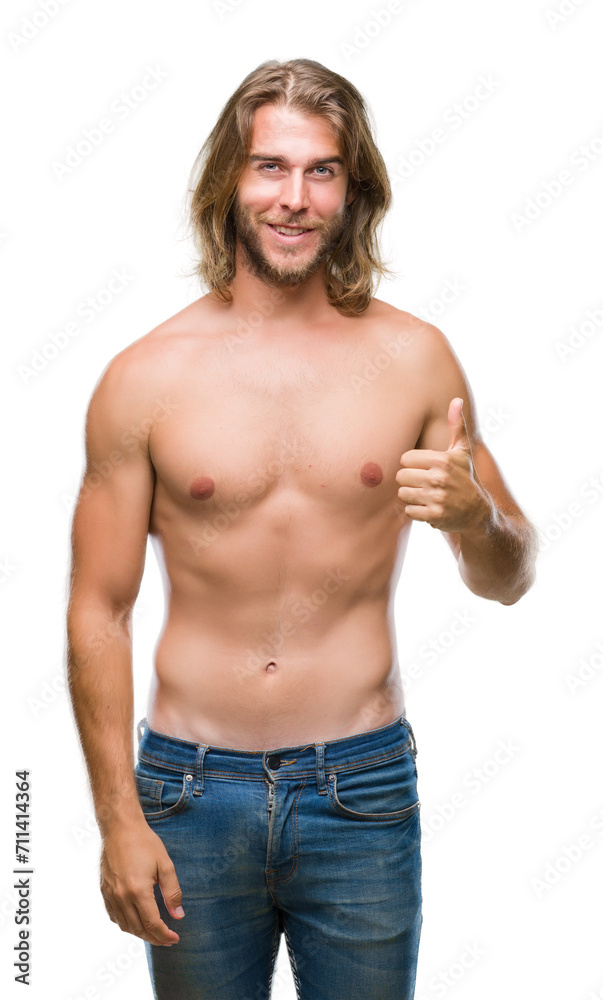 Fototapeta premium Young handsome shirtless man with long hair showing sexy body over isolated background doing happy thumbs up gesture with hand. Approving expression looking at the camera with showing success.