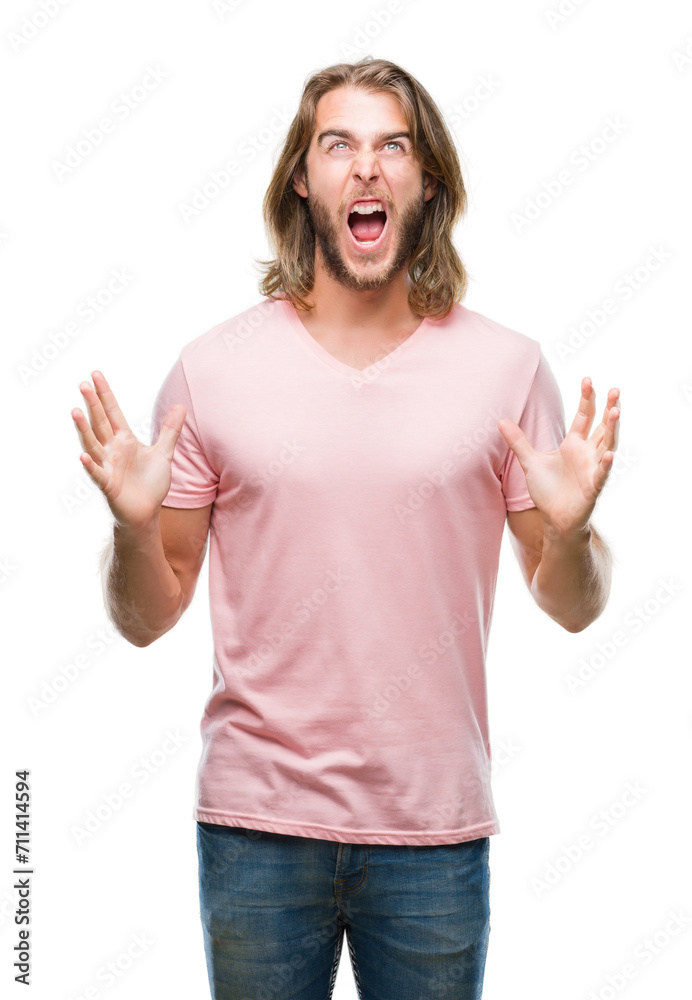 Young handsome man with long hair over isolated background crazy and mad shouting and yelling with aggressive expression and arms raised. Frustration concept. Young handsome man with long hair over isolated background crazy and mad shouting and yelling with aggressive expression and arms raised. Frustration concept.