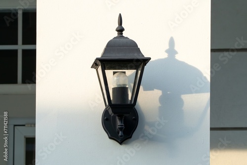 Antique black lamp lantern in white wall as a decoration