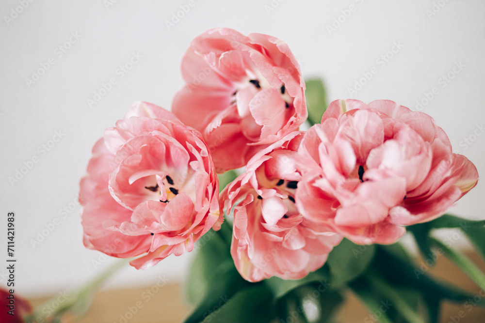 Beautiful tulips close up in vase on rustic background. Stylish floral bouquet. Happy Valentines day and happy mother's day. Tender pink flowers