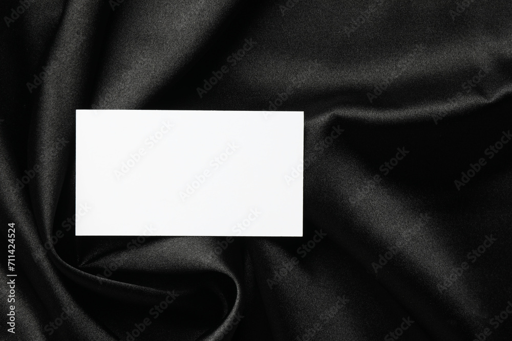 Blank business card on black fabric, top view. Mockup for design Blank business card on black fabric, top view. Mockup for design