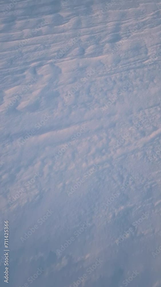 Winter snowdrifts abstract texture of snow shaped by the wind on an empty land in the sunset light Winter snowdrifts abstract texture of snow shaped by the wind on an empty land in the sunset light