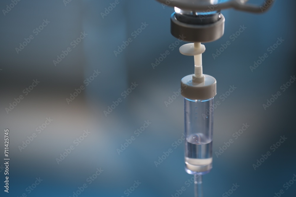 IV drip against blurred background, space for text