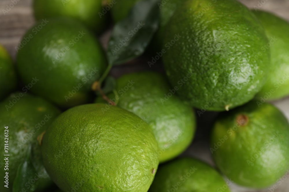 Pile of fresh limes on table, closeup Pile of fresh limes on table, closeup