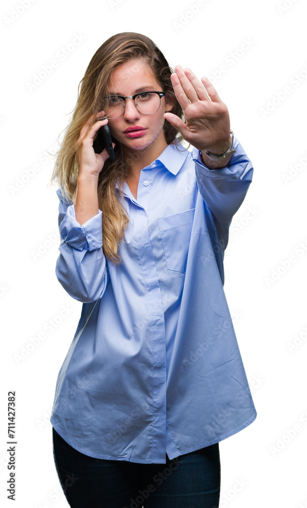Young beautiful blonde business woman calling using smartphone over isolated background with open hand doing stop sign with serious and confident expression, defense gesture Young beautiful blonde business woman calling using smartphone over isolated background with open hand doing stop sign with serious and confident expression, defense gesture
