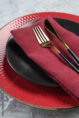 Clean plates  cutlery and napkin on table  closeup