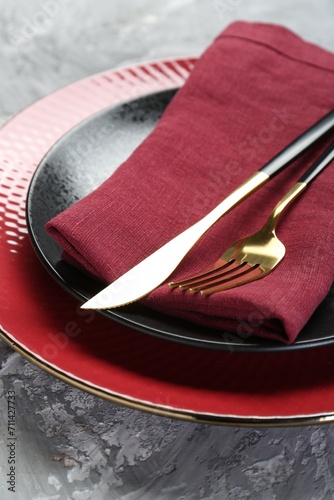 Clean plates, cutlery and napkin on table, closeup