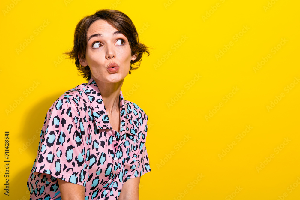 Profile portrait of speechless impressed person pouted lips look empty space ad isolated on yellow color background Profile portrait of speechless impressed person pouted lips look empty space ad isolated on yellow color background