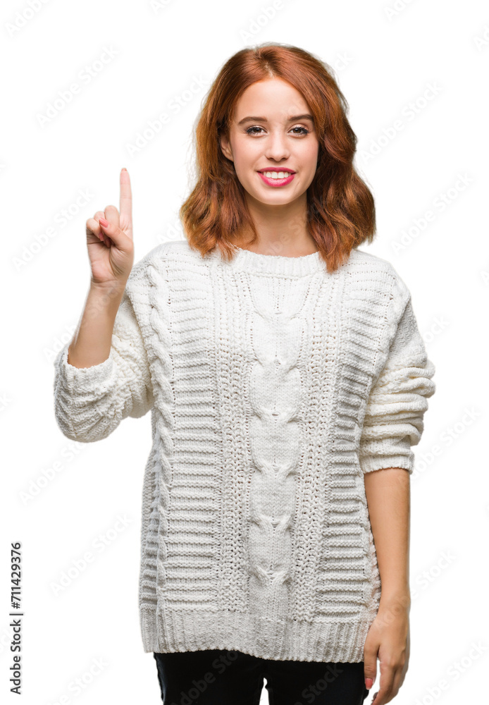 Young beautiful woman over isolated background wearing winter sweater showing and pointing up with finger number one while smiling confident and happy. Young beautiful woman over isolated background wearing winter sweater showing and pointing up with finger number one while smiling confident and happy.