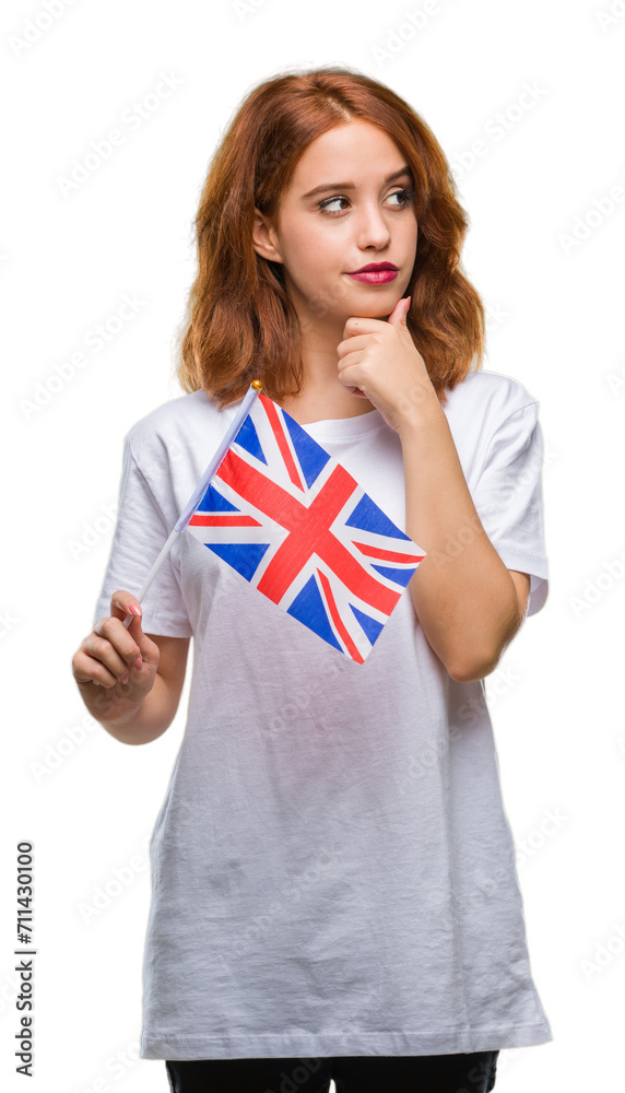 Young beautiful woman holding flag of united kingdom over isolated background serious face thinking about question, very confused idea Young beautiful woman holding flag of united kingdom over isolated background serious face thinking about question, very confused idea