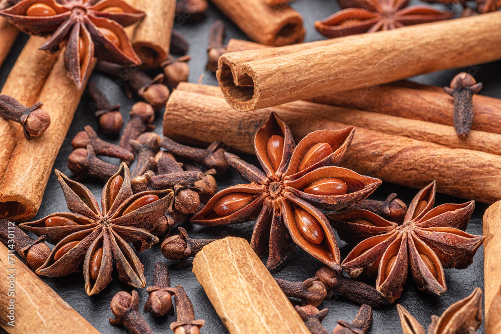 Lots of three spices for mulled wine – star anise, cinnamon and clove, macro. Lots of three spices for mulled wine – star anise, cinnamon and clove, macro.