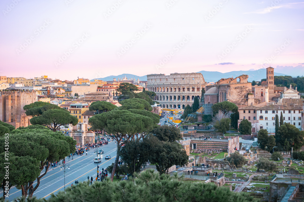 Italy, Rome, Coliseum (Colosseo), Imperial Forums (Fori Imperiali) and aerial panoramic view of the ancient city. Via dei Fori Imperiali (Imperial Forums street)