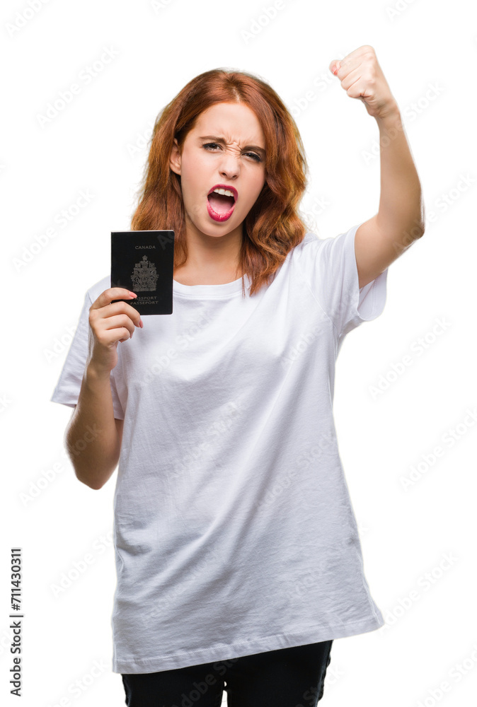 Young beautiful woman holding passport of canada over isolated background annoyed and frustrated shouting with anger, crazy and yelling with raised hand, anger concept