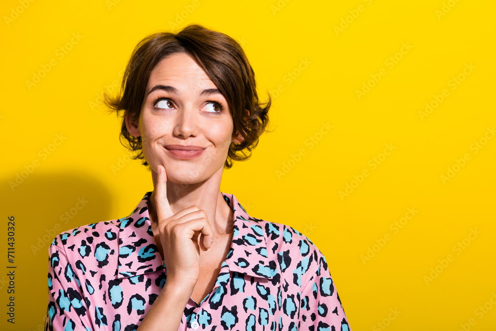 Photo of adorable minded lady finger touch chin look interested empty space isolated on yellow color background