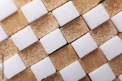 White and brown sugar cubes as background, top view