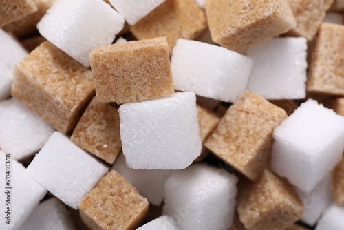 White and brown sugar cubes as background, closeup