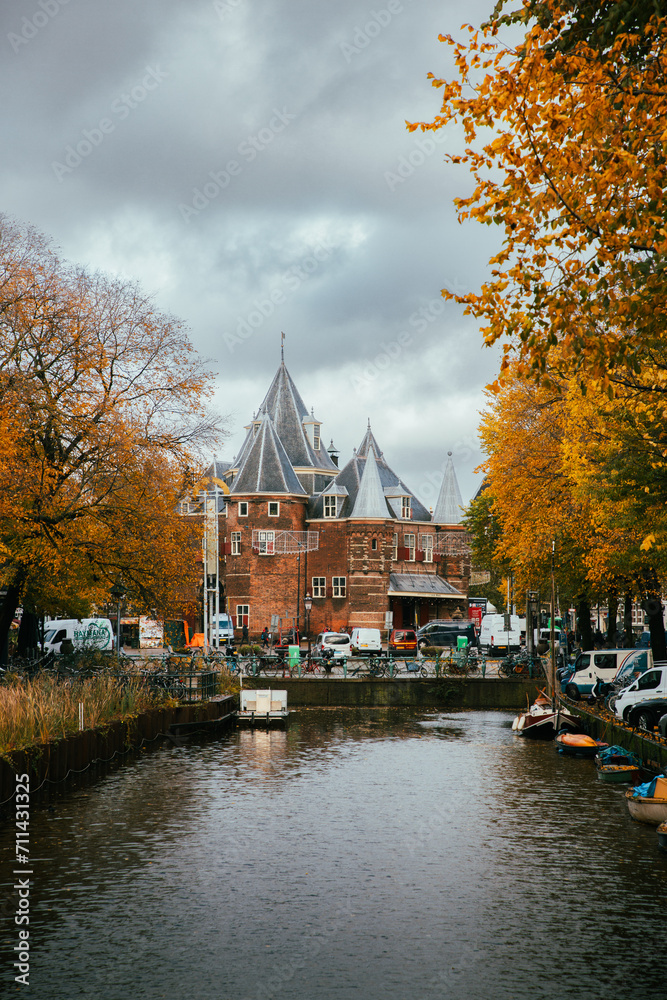 Amsterdam canals with old castle in the background and autumn colours cloudy day Amsterdam canals with old castle in the background and autumn colours cloudy day