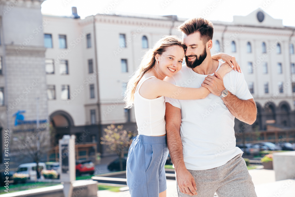 Smiling beautiful woman and her handsome boyfriend. Woman in casual summer clothes. Happy cheerful family. Female having fun. Couple posing in street at sunny day. Having tender moments