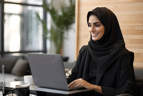 a hijab woman working with her laptop
