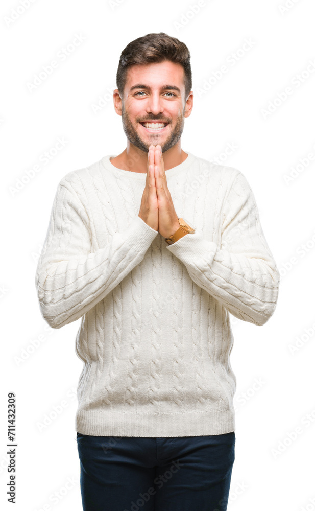 Young handsome man wearing winter sweater over isolated background praying with hands together asking for forgiveness smiling confident. Young handsome man wearing winter sweater over isolated background praying with hands together asking for forgiveness smiling confident.