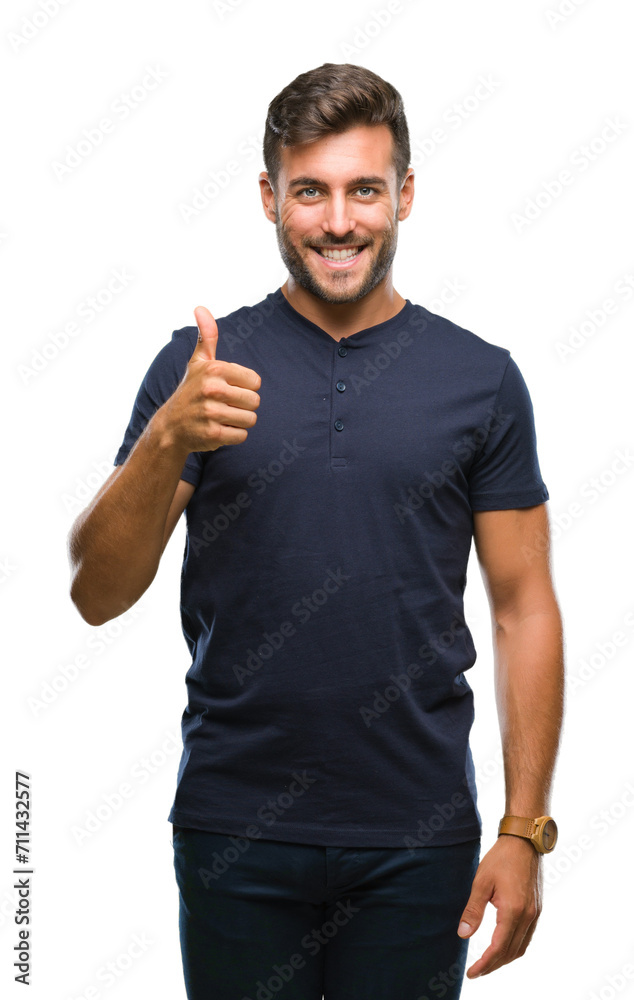 Young handsome man over isolated background doing happy thumbs up gesture with hand. Approving expression looking at the camera with showing success. Young handsome man over isolated background doing happy thumbs up gesture with hand. Approving expression looking at the camera with showing success.