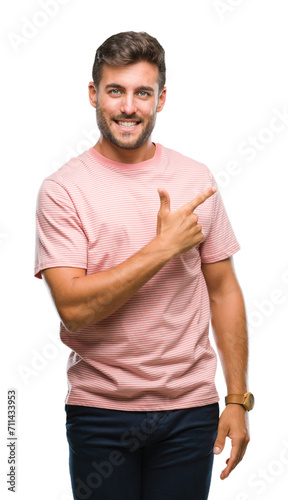 Young handsome man over isolated background cheerful with a smile of face pointing with hand and finger up to the side with happy and natural expression on face looking at the camera.