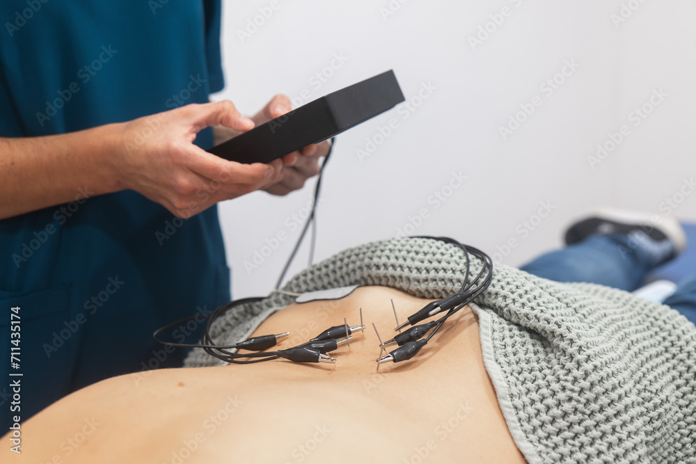 © ADDICTIVE STOCK - Medical Professional Attaching ECG Electrodes to Patient