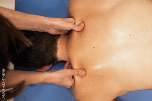 Manual neck massage by professional physiotherapist photo