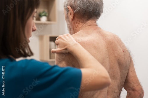 Elderly man receiving physical therapy at home photo